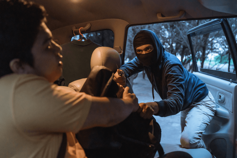 Car robbery in progress: masked thief snatches bag from passenger. Nighttime crime scene inside vehicle.
