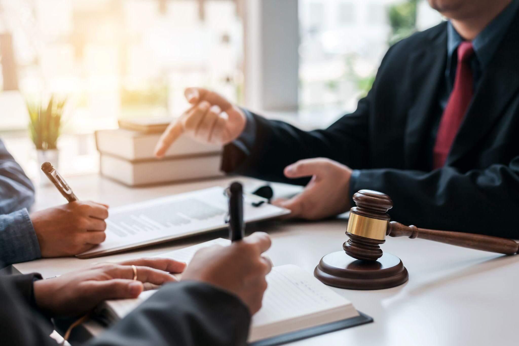 Two people at table with dual judges in court setting