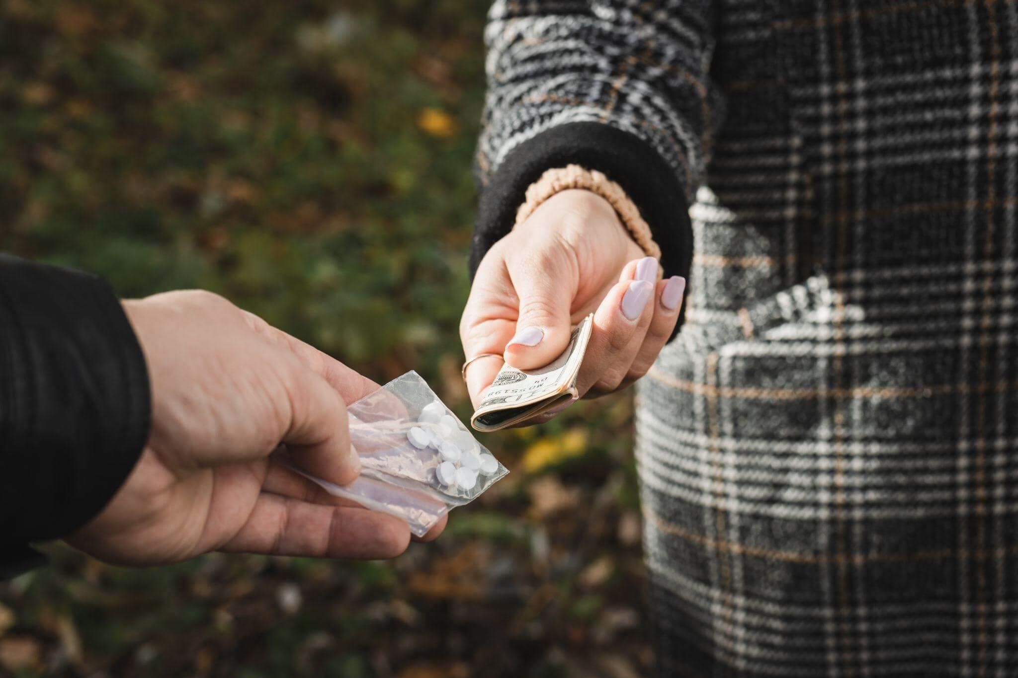 a person handing another person something out of a bag