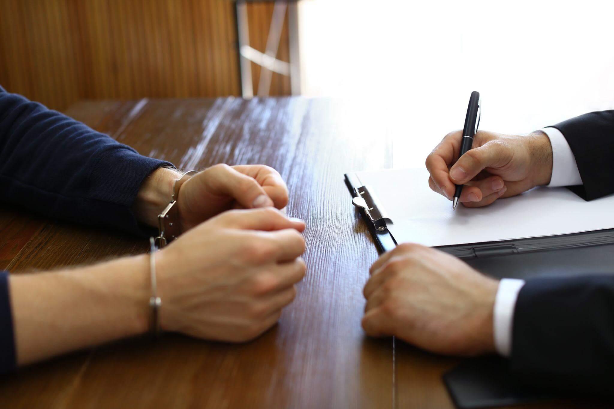 Two people collaborating on paperwork at a table