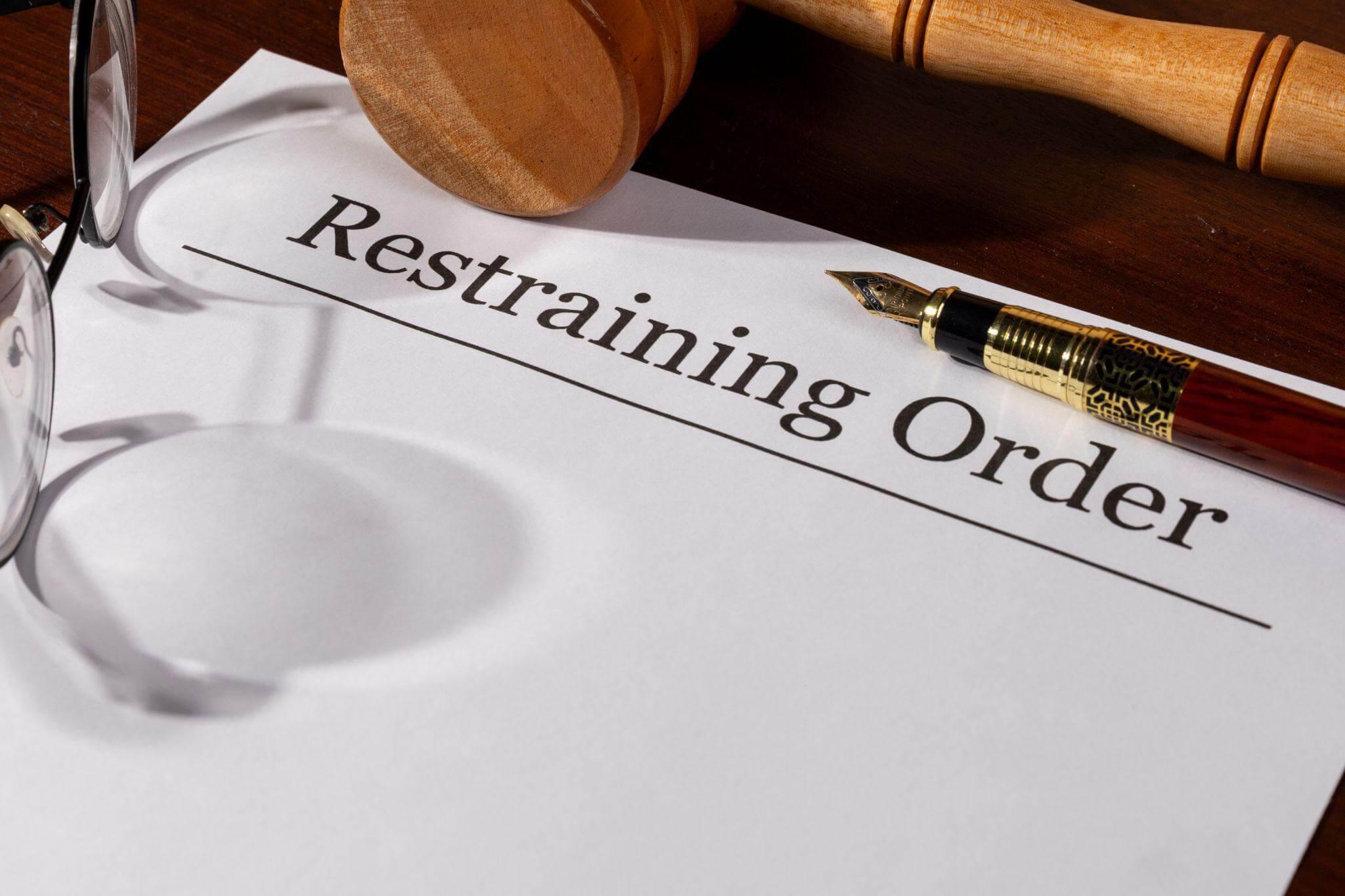 a restraining order with a pen and glasses